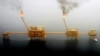 FILE - Gas flares from an oil production platform at the Soroush oil fields in the Persian Gulf, south of Tehran, July 25, 2005.