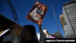FILE - Pro-life and pro-choice advocates hold a protest rally outside the New South Wales Parliament in Sydney on Aug. 6, 2019.
