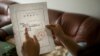 China Lawyers Crackdown: In this Wednesday, July 6, 2016 photo, Yuan Shanshan, the wife of detained Chinese lawyer Xie Yanyi, holds an official notice of Xie's detention from the Tianjin Public Security Bureau in their apartment in Miyun, on the outskirts of Beijing. 
