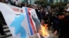 South Korean protesters burn a portrait of North Korean leader Kim Jong Un during a rally against a visit of North Korean Hyon Song Wol, head of North Korea's art troupe, in front of Seoul Railway Station in Seoul, Jan. 22, 2018.