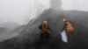 FILE - Employees from the local Entry-Exit Inspection and Quarantine Bureau collect samples of coal at a port in Rizhao, Shandong province.