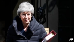 FILE - Britain's Prime Minister Theresa May leaves 10 Downing Street for the House of Commons for her weekly Prime Minister's questions in London, May 1, 2019.