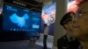 FILE - Visitors look at a display of information technologies at an exhibit highlighting China's achievements under five years of Xi Jinping's leadership at the Beijing Exhibition Hall in Beijing, China, Oct. 17, 2017.