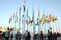 FILE - People attend the Damascus International Trade Fair in the Syrian capital, Aug. 30, 2019.