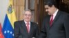 FILE - Cuba's Raul Castro (L) shakes hands with Venezuela's Nicolas Maduro in Caracas, Venezuela, March 5, 2018. 