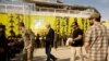 U.S. envoy William Roebuck, center, leaves the podium after speaking at a ceremony to celebrate U.S.-backed Syrian Democratic Forces defeat of Islamic State militants in Baghouz, at al-Omar Oil Field base, Syria, March 23, 2019