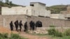 FILE - Malian Police officers take position outside Campement Kangaba, a tourist resort near Bamako, Mali, June. 19, 2017.