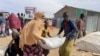 FILE - Food supplies are distributed during a visit by WFP Regional Director to a camp for the IDP in Adadle, Ethiopia, Jan. 22, 2022. 