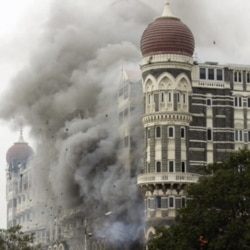 FILE - In this Nov. 29, 2008 file picture, smoke billows from the landmark Taj Mahal hotel in Mumbai, India after an attack by gunmen.