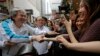 Chief Executive candidate, Hong Kong's former Financial Secretary John Tsang, left, shakes hands with his supporters at an election campaign in Hong Kong, March 24, 2017. 