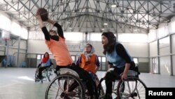 Disabled Afghan women play basketball at the Orthopaedic Center of the International Committee of the Red Cross in Kabul, Afghanistan, Feb. 7, 2020. 