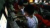 FILE - Two Vietnamese students use Facebook at an internet cafe near their dormitory, in Hanoi, Vietnam, Sept. 27, 2012.