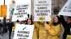 FILE - Demonstrators from Amnesty International hold placards outside the Saudi Arabian Embassy to urge Saudi authorities to release jailed women's rights activists Loujain al-Hathloul, Eman al-Nafjan and Aziza al-Yousef in Paris, France, March 8, 2019. 