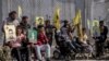 Wounded Kurdish fighters hold portraits of comrades who were killed fighting against IS militants, during a demonstration outside the U.N. building in Qamishli, northeast Syria, against an anticipated Turkish incursion, Oct. 8, 2019.