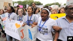 FILE - Demonstrators in downtown Houston during a March for Our Lives protest for gun legislation and school safety, March 24, 2018. 