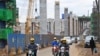 Motorists drive on Mombasa road, next to the ongoing construction site of the Nairobi Expressway, undertaken by the Chinese contractor China Road and Bridge Corporation (CRBC), in Nairobi, Kenya, July 12, 2021.
