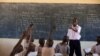 An instructor teaches students in Lodwar, Turkana, Kenya. He supplements his teachers salary with a small shop managed by him and his wife. (K. Prinsloo/ ARETE/UNESCO)