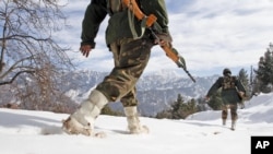 FILE - Indian army soldiers patrol near the Line of Control (LOC), the line that divides Kashmir between India and Pakistan.