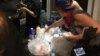 Volunteers hand out donated water bottles and antidotes to tear gas (masks, milk of magnesia, and vinegar) as protestors prepare to leave Romare Bearden Park and march through Charlotte, North Carolina, Sept. 24, 2016.