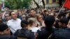 Russian opposition candidate and lawyer at the Foundation for Fighting Corruption Lyubov Sobol, center, and candidate Ivan Zhdanov, 2nd left, stand with other protesters in front of a police line during a protest in Moscow, July 14, 2019.