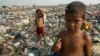 Children scavengers pose with their metal hooks used to rummage garbage amidst a mountain of trash in a Manila dumpsite, August 20, 2002.