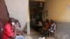 FILE - Patients wait their turn at Saint Paul Catholic Hospital, to receive free concoctions made by Samuel Kleda, Archbishop of Douala, who claims that they have helped treat COVID-19 patients, in Douala, Cameroon, June 9, 2020.
