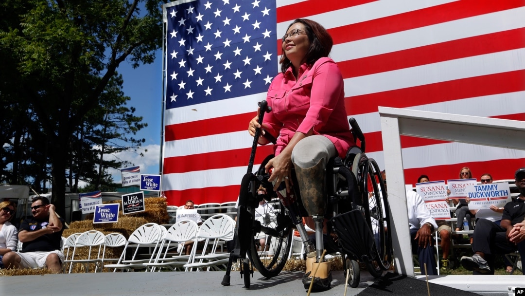 FILE - Democratic Rep. Tammy Duckworth, an Iraq War veteran who lost both of her legs in combat, acknowledges applause from supporters during a rally in Springfield, Illilois, Aug. 20, 2015. Some polls show ahead in her quest to unseat incumbent Republica