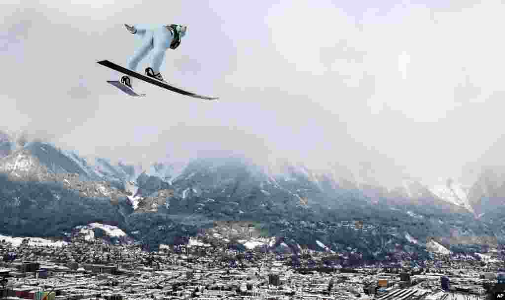 Austria&#39;s Markus Schiffner soars through the air during a trial jump at the third stage of the 67th four hills ski jumping tournament in Innsbruck, Austria.
