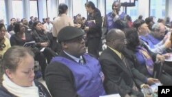 Haitian immigrants learn about a new immigration program for Haitians living in the United States at the Federal Building in Manhattan, New York
