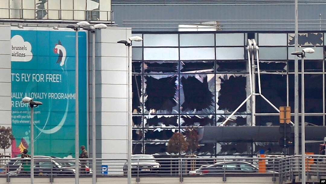 FILE - Broken windows are seen at the scene of explosions at the Brussels airport, Belgium, March 22, 2016. 