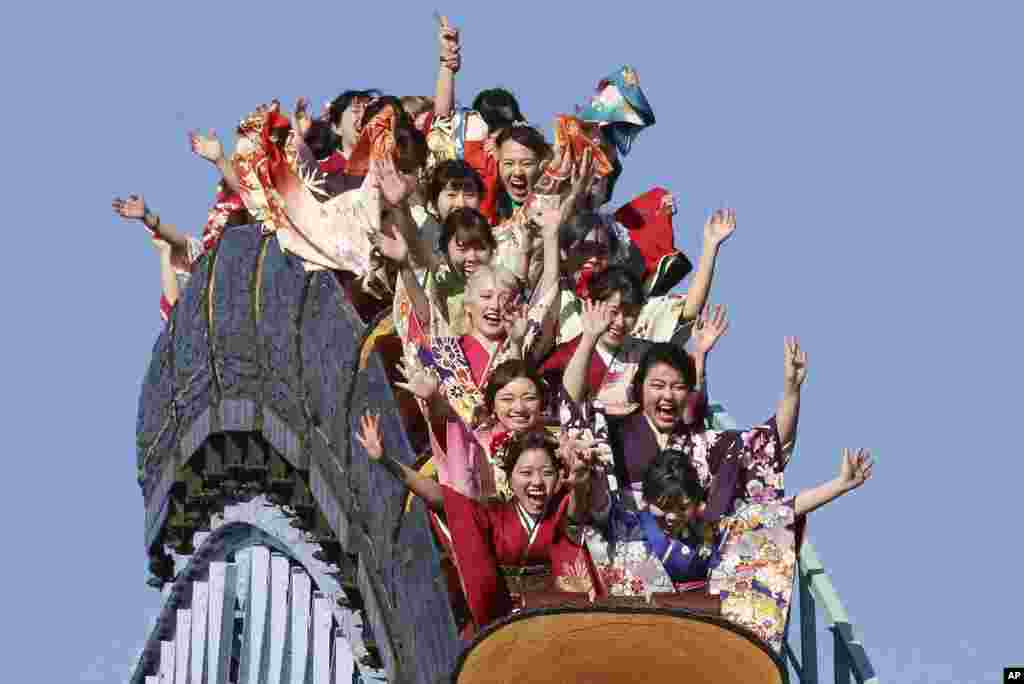 Kimono-clad women who celebrate turning 20 years old, react as they ride a roller coaster at Toshimaen amusement park on Coming of Age Day, a national holiday, in Tokyo, Japan.