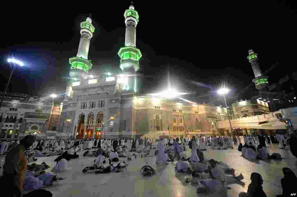 Muslim piligrims wait to perform morning prayer in Mecca's Grand Mosque. Hundreds of thousands of Muslims poured into the holy city of Mecca, Saudi Arabia for the annual hajj pilgrimage, Oct. 13, 2013.