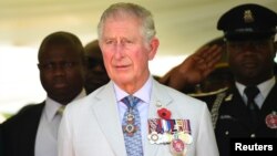 FILE - Britain's Charles, Prince of Wales stands during the honoring of the fallen heroes of the two World Wars in Abuja, Nigeria, Nov. 8, 2018.
