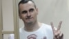 Ukrainian filmmaker Oleh Sentsov gestures as the verdict is delivered at his trial in Rostov-on-Don, Russia, Aug. 25, 2015.