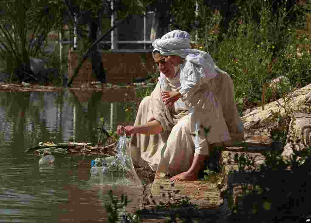 Followers of the Sabean Mandaeans, a pre-Christian sect that follows the teachings of John the Baptist, perform their rituals alongside the Tigris river during a celebration marking &#39;Banja&#39; or Creation Feast in central Baghdad, Iraq.