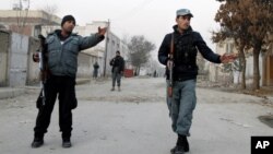 Afghan policemen stand guard near the scene where Afghanistan's Intelligence Chief Asadullah Khalid was wounded in an assassination attempt in Kabul, Afghanistan, December 6, 2012.
