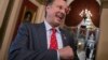 Rep. Dave Brat, R-Va., a member of the conservative House Freedom Caucus, speaks with a reporter just before passage of the Republican tax reform bill in the House of Representatives, on Capitol Hill, in Washington, Dec. 19, 2017.