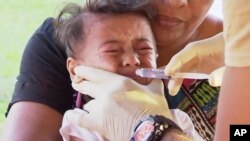 FILE - In this November 2019, image from video, a child gets vaccinated at a health clinic in Apia, Samoa.