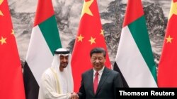 Abu Dhabi's Crown Prince Sheikh Mohammed bin Zayed Al Nahyan shakes hands with Chinese President Xi after witnessing a signing ceremony in Beijing, July 22, 2019.