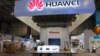 FILE - Workers prepare a stand for Huawei at the venue of the 21st Century Maritime Silk Road International Expo in Dongguan, in Guangdong Province, China, Oct. 28, 2015. 