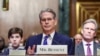 FILE - Scott Bessent, U.S. President-elect Donald Trump's nominee to be secretary of treasury, looks on next to his husband John Freeman and son Cole, on the day he testifies during a Senate Committee on Finance confirmation hearing on Capitol Hill in Washington, Jan. 16, 2025. 