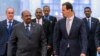 FILE - In this photo released by the Syrian official news agency SANA, Syrian President Bashar al-Assad, right, meets with Sudan's President Omar al-Bashir in Damascus, Syria, Dec. 16, 2018. 