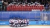 North Korea fans, top, wave the Korean unification flag as players of a combined Koreas team gather at the end of a women's hockey game against Switzerland, at the 2018 Winter Olympics in Gangneung, South Korea, Feb. 10, 2018.