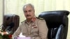 FILE - Libya's eastern-based commander Khalifa Haftar attends a security conference, in Benghazi, Libya, Oct. 14, 2017.