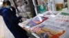 A picture of Chinese President Xi Jinping attending a virtual meeting with US President Joe Biden via video link is seen on a newspaper front page, at a newsstand in Beijing, China, Nov. 17, 2021. 