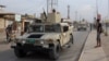 An Iraqi army vehicle patrols after a car bomb attack on Oct. 23, 2018, killed six people and wounded 26 more at a market in Al Qayyarah, located south of the Islamic State group's former Iraqi capital of Mosul.