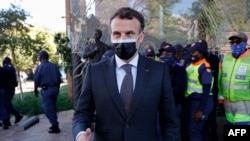 French President Emmanuel Macron gives a thumbs up after concluding his visit to the Nelson Mandela Foundation in Johannesburg on May 29, 2021.
