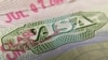 This photo illustration shows a visa stamp on a foreign passport in Los Angeles on June 6, 2020. - The United States said July 6 it would not allow foreign students to remain in the country if all of their classes are moved online.