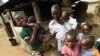 FILE - Young Cameroonian refugees carry children in Agborkim town, Etung district of Cross Rivers State, southeast Nigeria, Feb. 2, 2018. Millions of Cameroonian children reportedly do not have required birth certificates. 