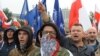 FILE - Protesters shout anti-migrant slogans as several thousand right-wing nationalists rally, demonstrating against EU proposed quotas for Poland to spread the human tide of refugees around Europe, in Warsaw, Poland, Sept. 12, 2015.